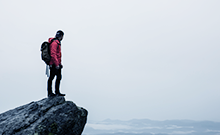 Hiker standing over a mountain cliff